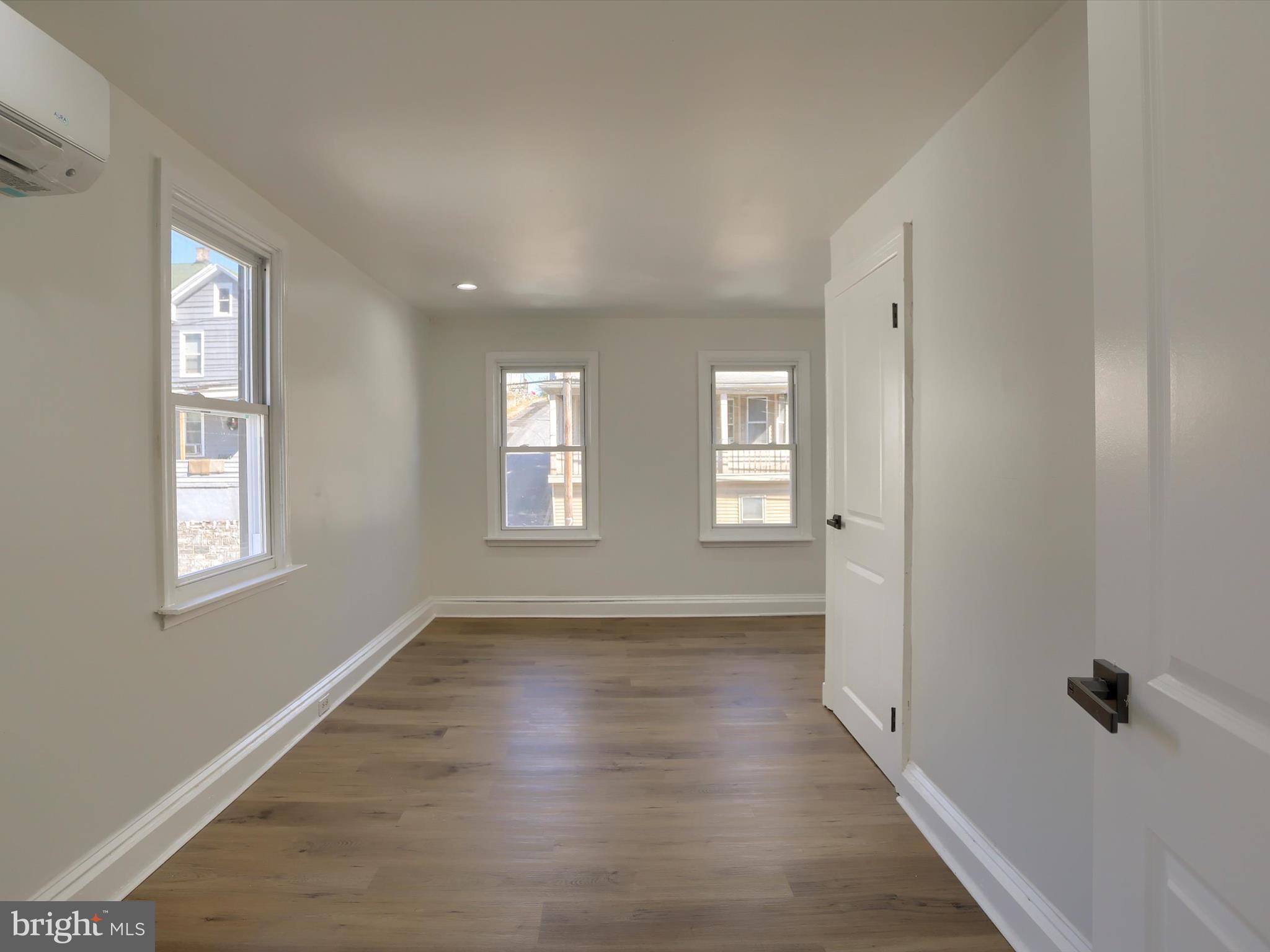 556 North 2nd Street Steelton, PA 17113 - Photo 25 of 33 a view of an empty room with wooden floor and a window