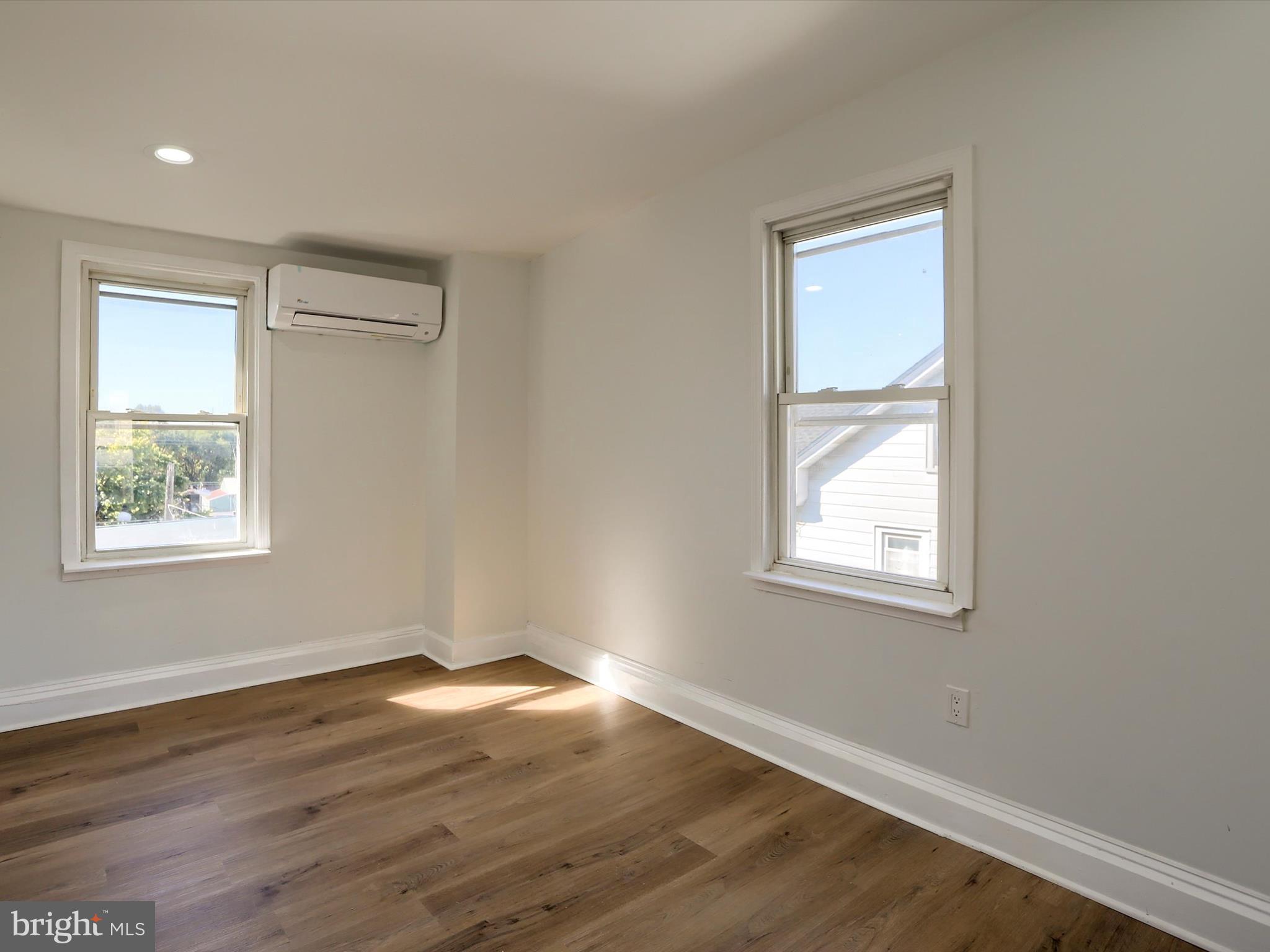 556 North 2nd Street Steelton, PA 17113 - Photo 27 of 33 a view of an empty room with wooden floor and a window