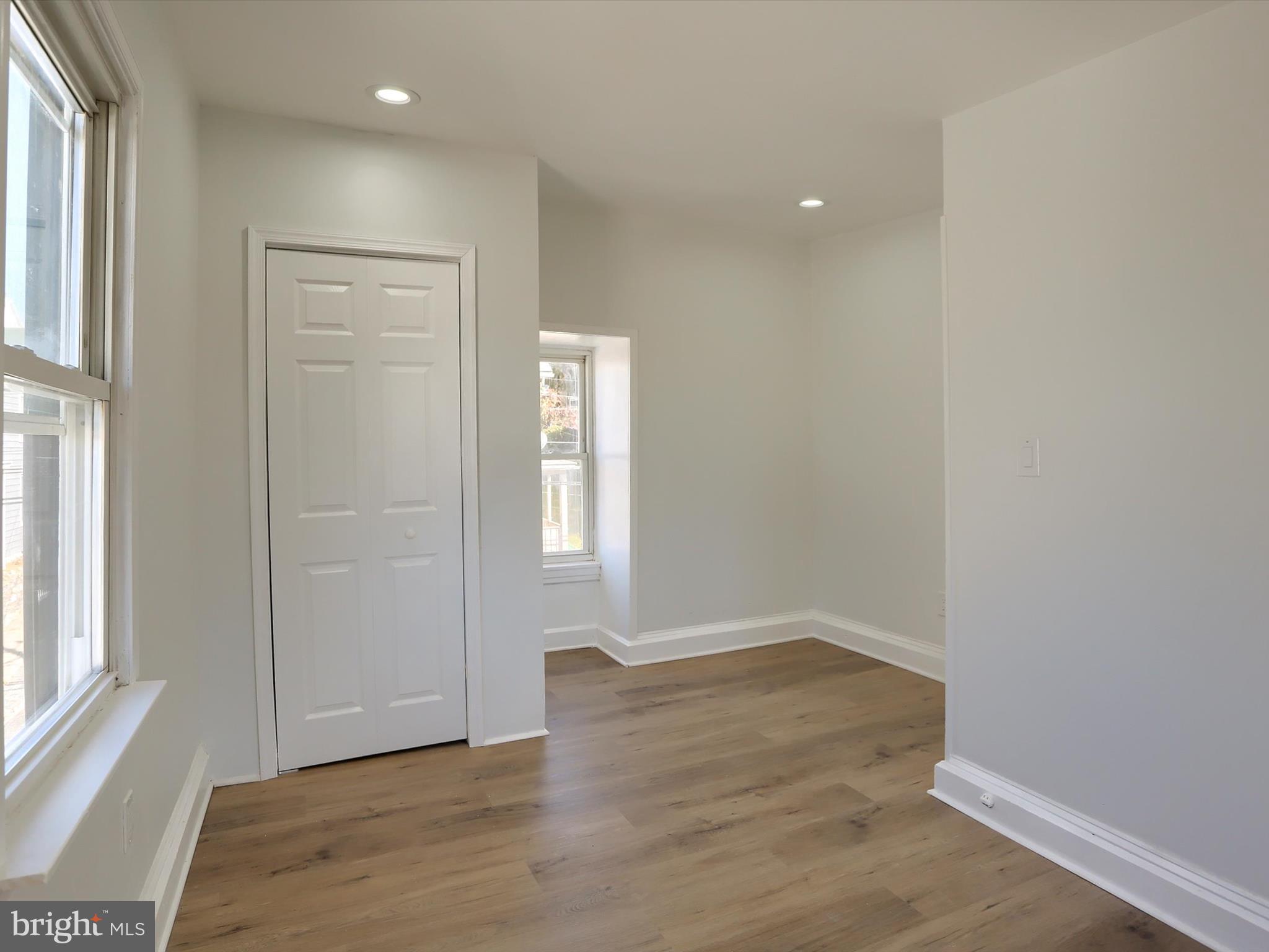 556 North 2nd Street Steelton, PA 17113 - Photo 29 of 33 an empty room with wooden floor and windows