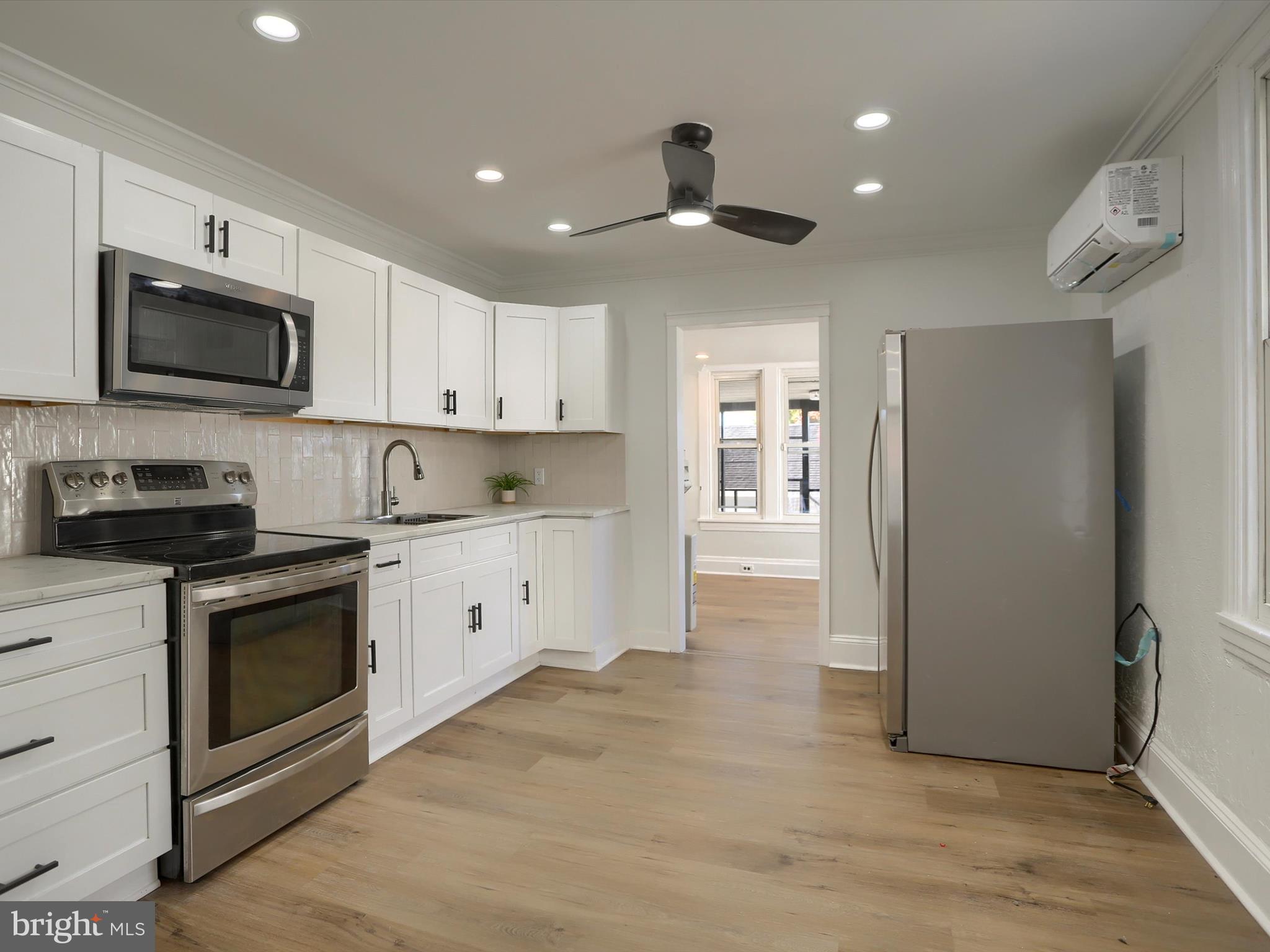 556 North 2nd Street Steelton, PA 17113 - Photo 10 of 33 a kitchen with stainless steel appliances granite countertop a stove a sink and a refrigerator