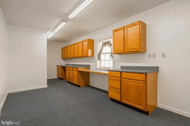 a kitchen with stainless steel appliances a sink and cabinets