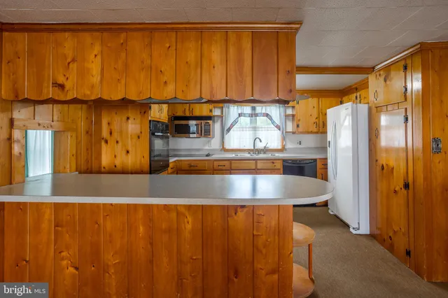 a kitchen with stainless steel appliances granite countertop a sink and cabinets