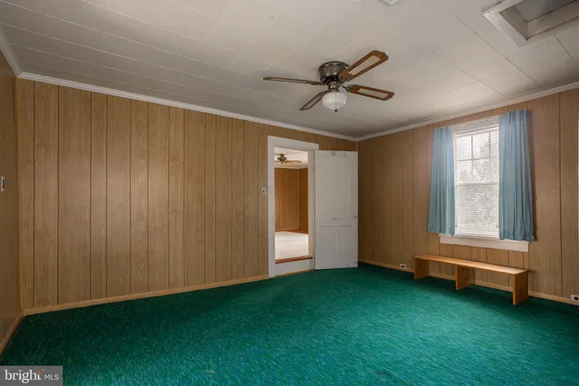 a view of room with yard and ceiling fan