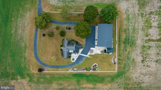 an aerial view of a house with outdoor space pool seating area and yard