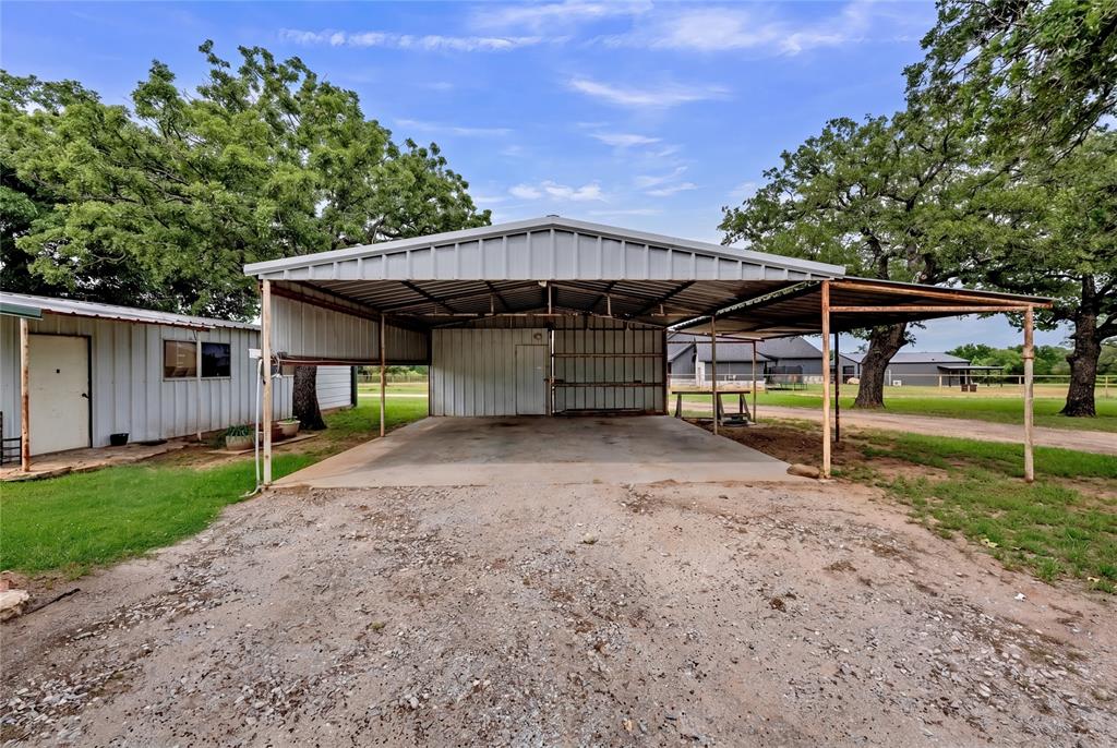 209 Dixie Road Millsap, TX 76066 - Photo 9 of 31 a view of a house with backyard and a tree
