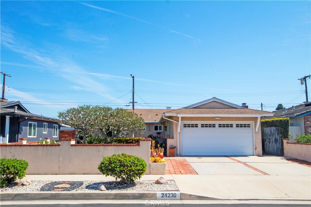 24230 Postmaster Avenue Harbor City, CA 90710 - Photo 1 of 31 a front view of a house with a garden