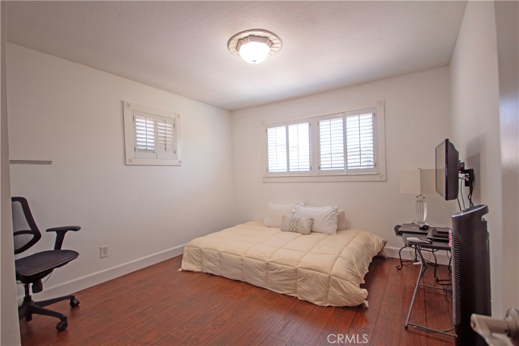 24230 Postmaster Avenue Harbor City, CA 90710 - Photo 12 of 31 a bedroom with a bed and wooden floor