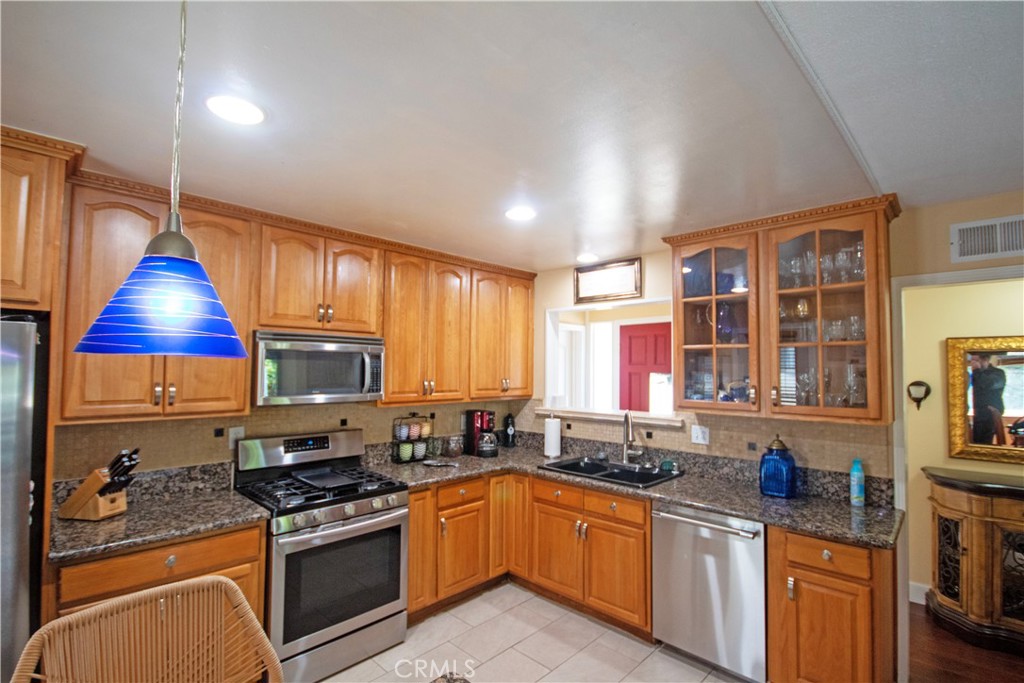 24230 Postmaster Avenue Harbor City, CA 90710 - Photo 17 of 31 a kitchen with stainless steel appliances granite countertop a stove and a sink