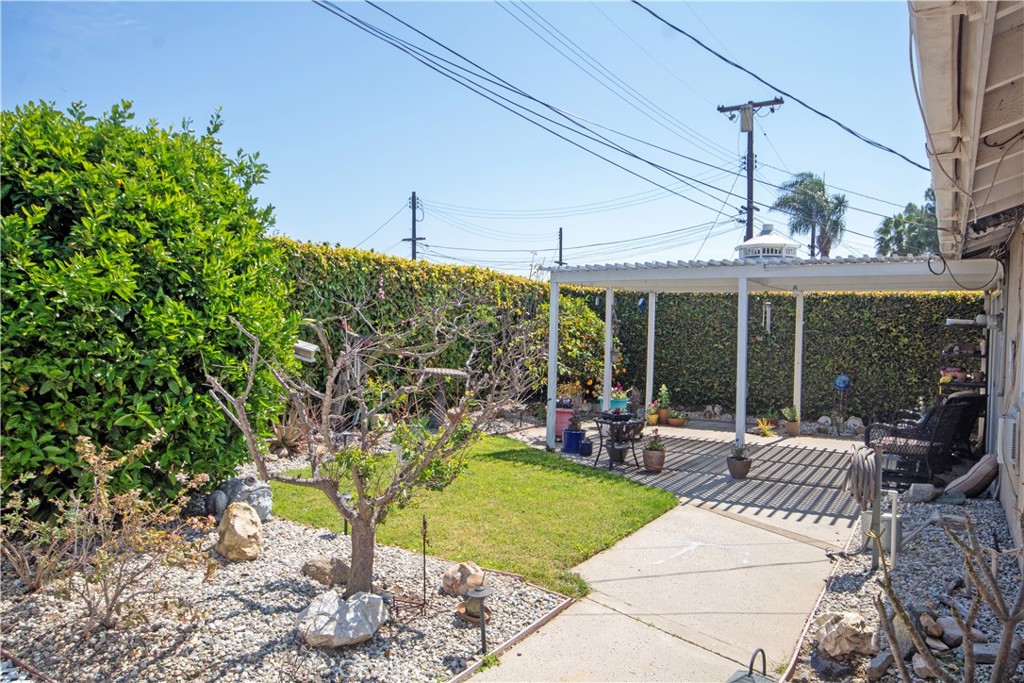 24230 Postmaster Avenue Harbor City, CA 90710 - Photo 27 of 31 a view of a patio with table and chairs potted plants and floor to ceiling window