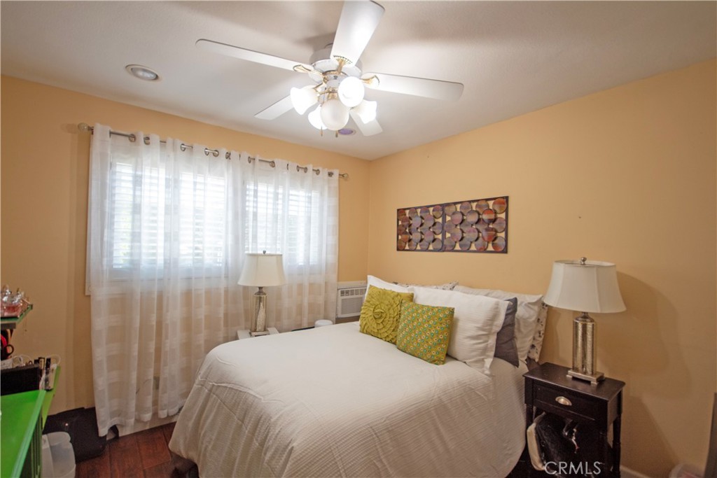 24230 Postmaster Avenue Harbor City, CA 90710 - Photo 10 of 31 a bedroom with a bed and a lamp