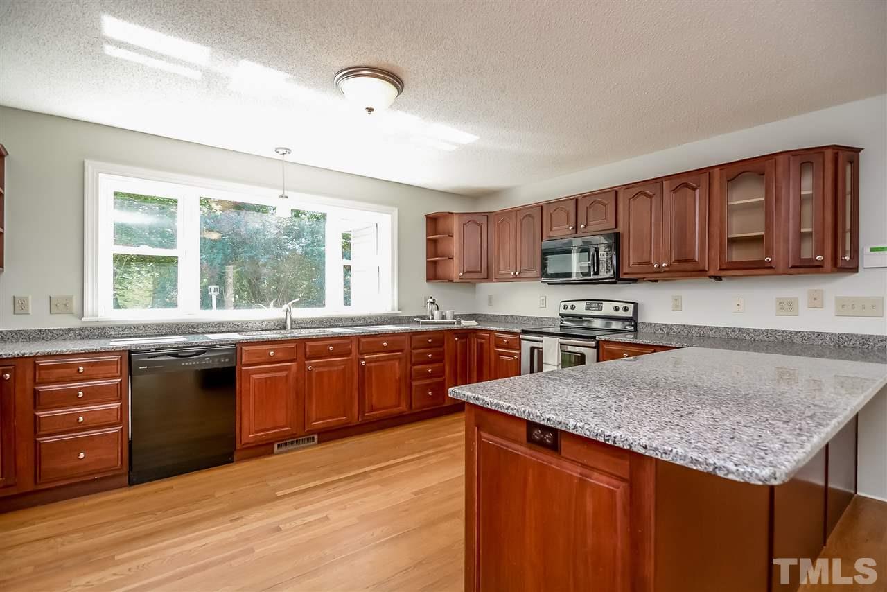 12925 Ghoston Road Wake Forest, NC 27587 - Photo 6 of 24 Spacious in size and counter space. Granite counters. Hardwood flooring.