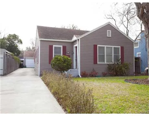a front view of house with yard and trees