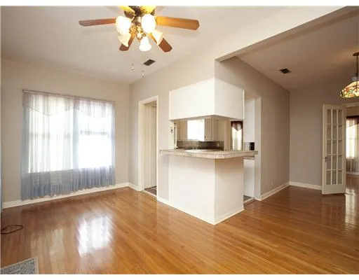 a room with kitchen island and wooden floor