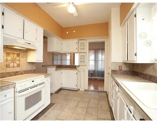 a kitchen with a stove a sink and a refrigerator