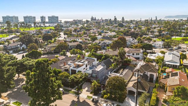 an aerial view of multiple houses with a yard