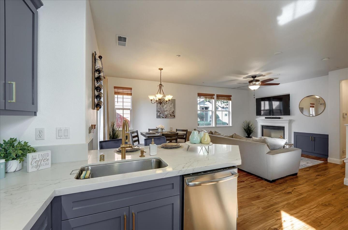 7929 Kipling Circle Gilroy, CA 95020 - Photo 11 of 39 a kitchen with kitchen island granite countertop a sink and living room view