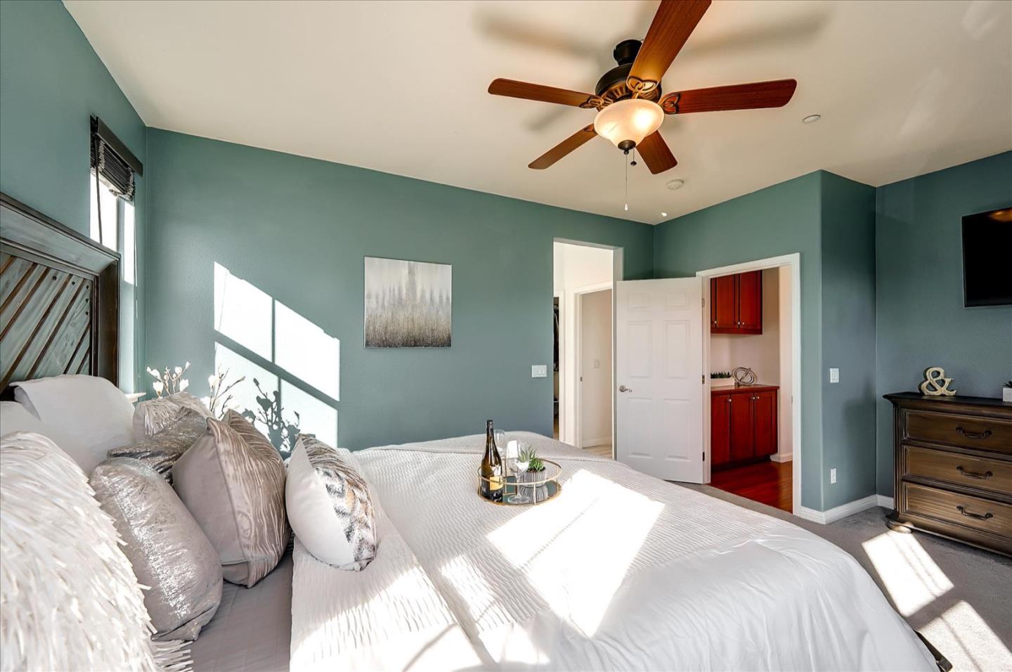 7929 Kipling Circle Gilroy, CA 95020 - Photo 22 of 39 a bedroom with a bed and a chandelier