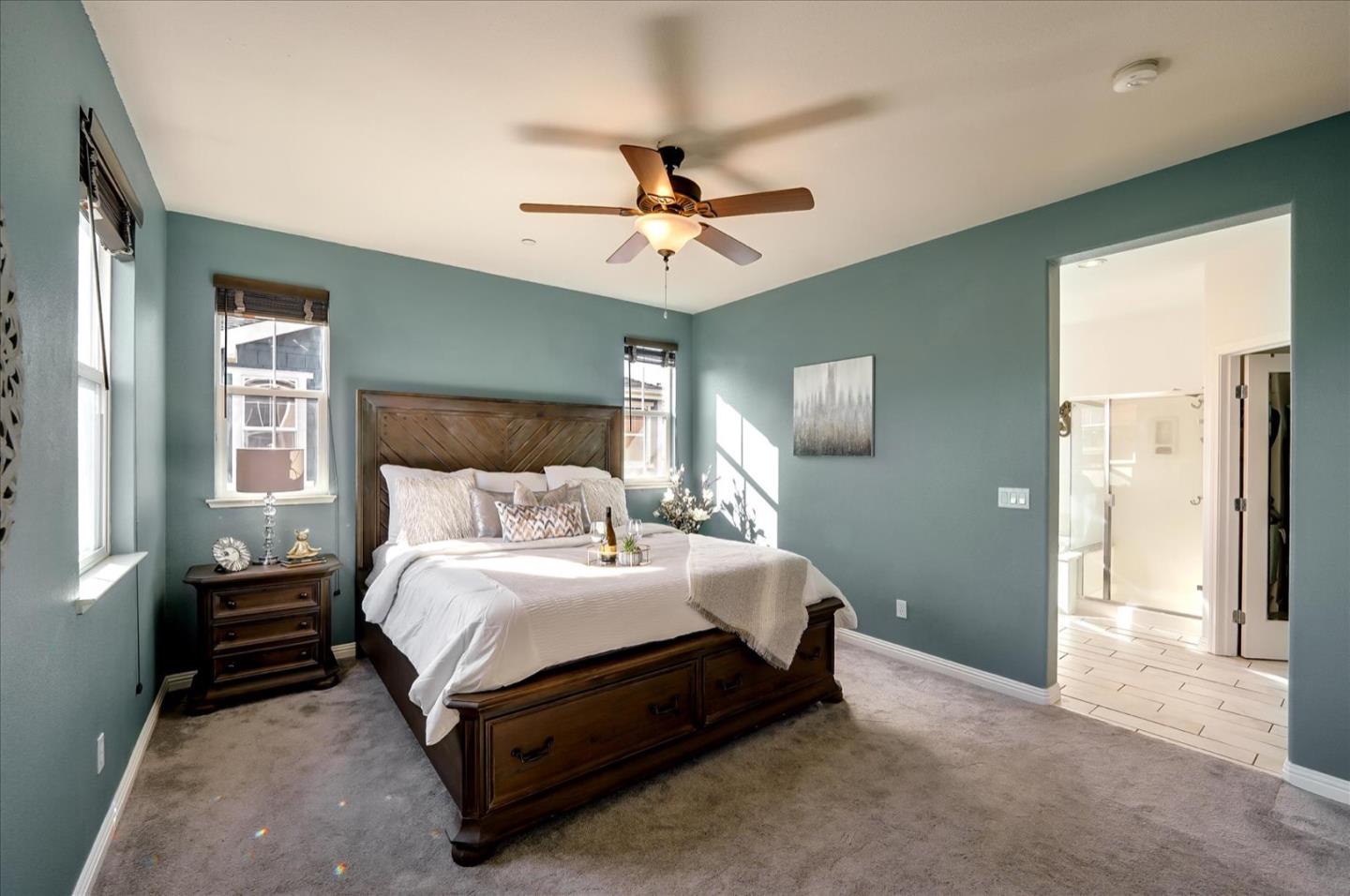 7929 Kipling Circle Gilroy, CA 95020 - Photo 23 of 39 a spacious bedroom with a bed and a chandelier