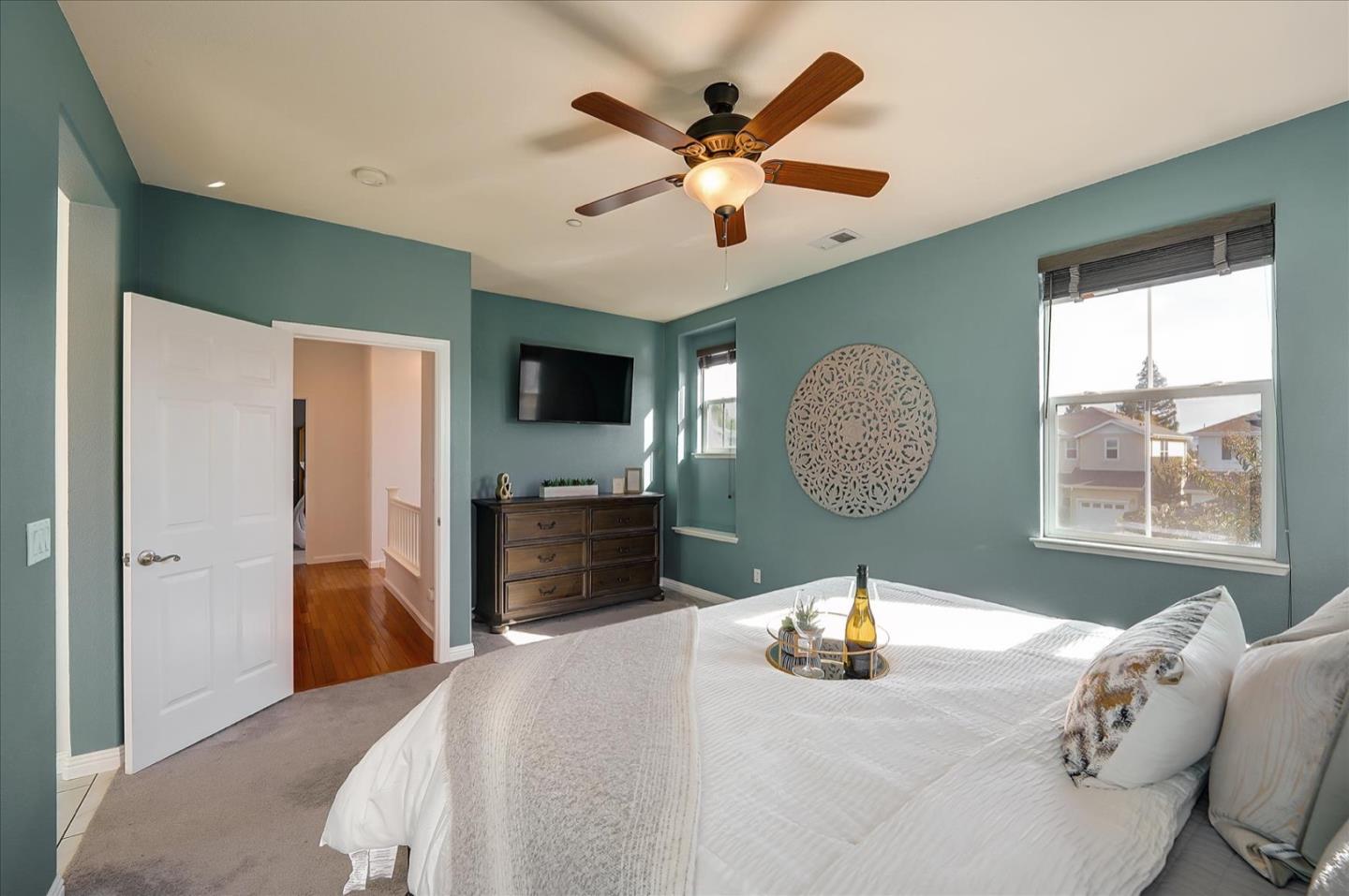 7929 Kipling Circle Gilroy, CA 95020 - Photo 25 of 39 a bedroom with a bed and a chandelier