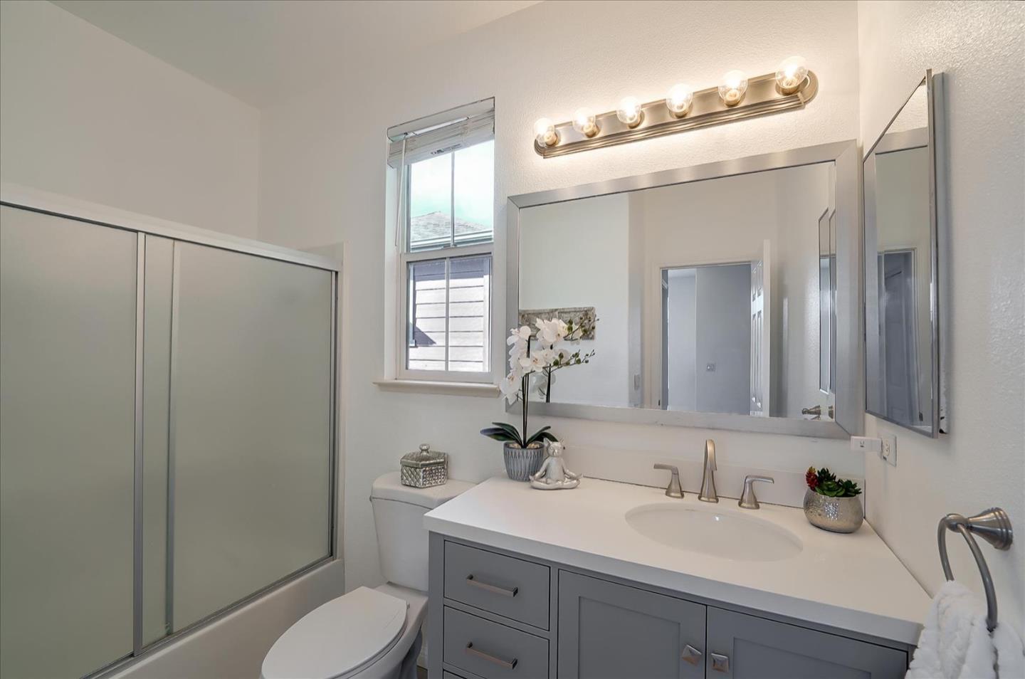 7929 Kipling Circle Gilroy, CA 95020 - Photo 27 of 39 a bathroom with a sink toilet a mirror and shower