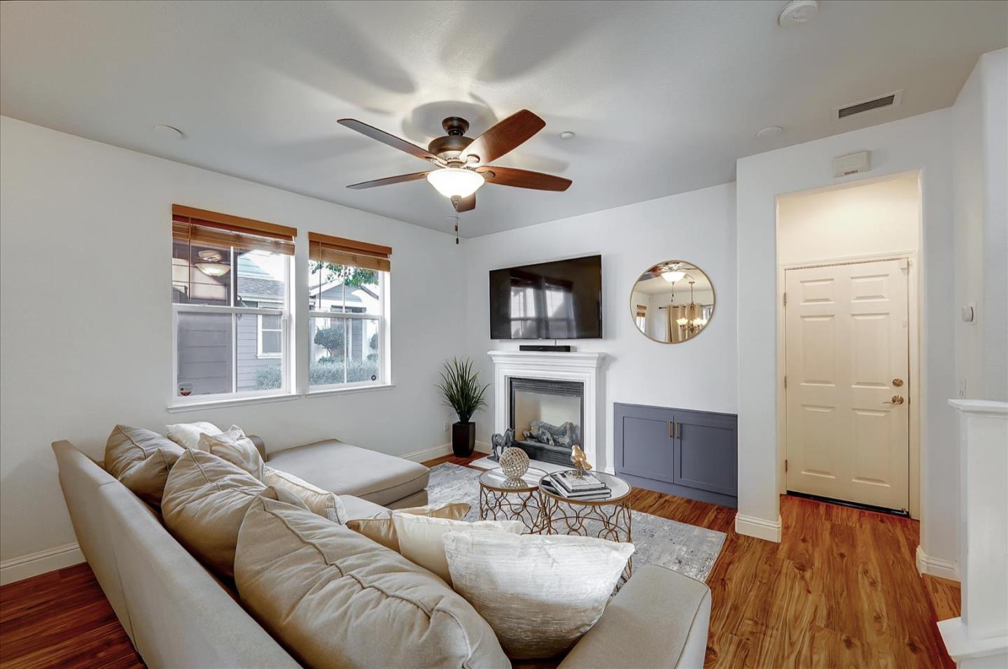 7929 Kipling Circle Gilroy, CA 95020 - Photo 6 of 39 a living room with furniture a fireplace and a flat screen tv
