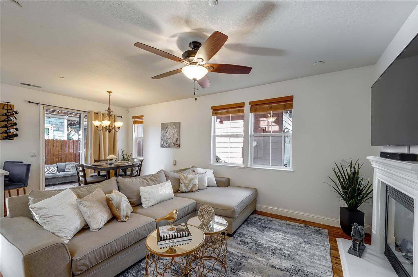 7929 Kipling Circle Gilroy, CA 95020 - Photo 7 of 39 a living room with furniture a chandelier and a flat screen tv