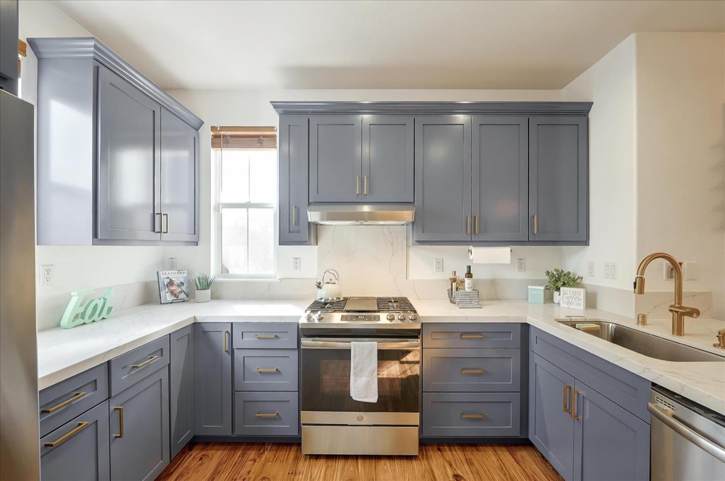 7929 Kipling Circle Gilroy, CA 95020 - Photo 9 of 39 a kitchen with granite countertop wooden cabinets and white appliances