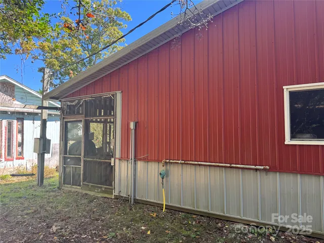 a backyard of a house with table and chairs