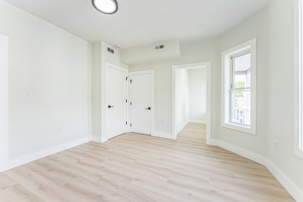 47 Brackett Street, Unit 3 Boston, MA 02135 - Photo 12 of 34 a view of empty room with wooden floor and fan