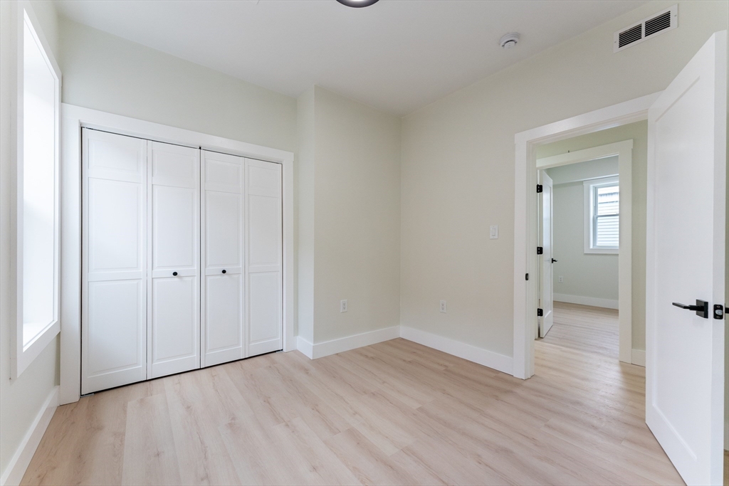 47 Brackett Street, Unit 3 Boston, MA 02135 - Photo 13 of 34 a view of an empty room and wooden floor