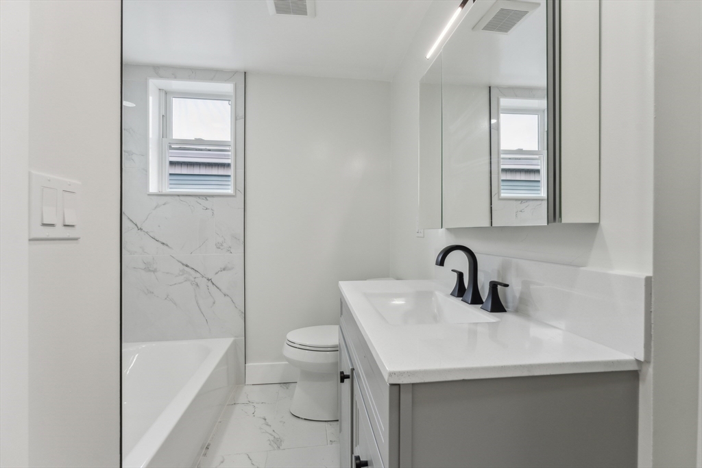 47 Brackett Street, Unit 3 Boston, MA 02135 - Photo 14 of 34 a bathroom with a sink a toilet and bathtub