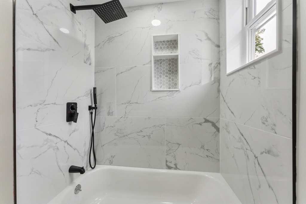 47 Brackett Street, Unit 3 Boston, MA 02135 - Photo 17 of 34 a bathroom with a bathtub and a shower