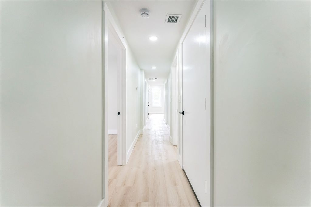 47 Brackett Street, Unit 3 Boston, MA 02135 - Photo 21 of 34 a view of a hallway with wooden floor