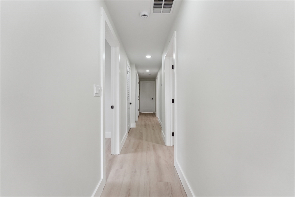 47 Brackett Street, Unit 3 Boston, MA 02135 - Photo 26 of 34 a view of a hallway with wooden floor