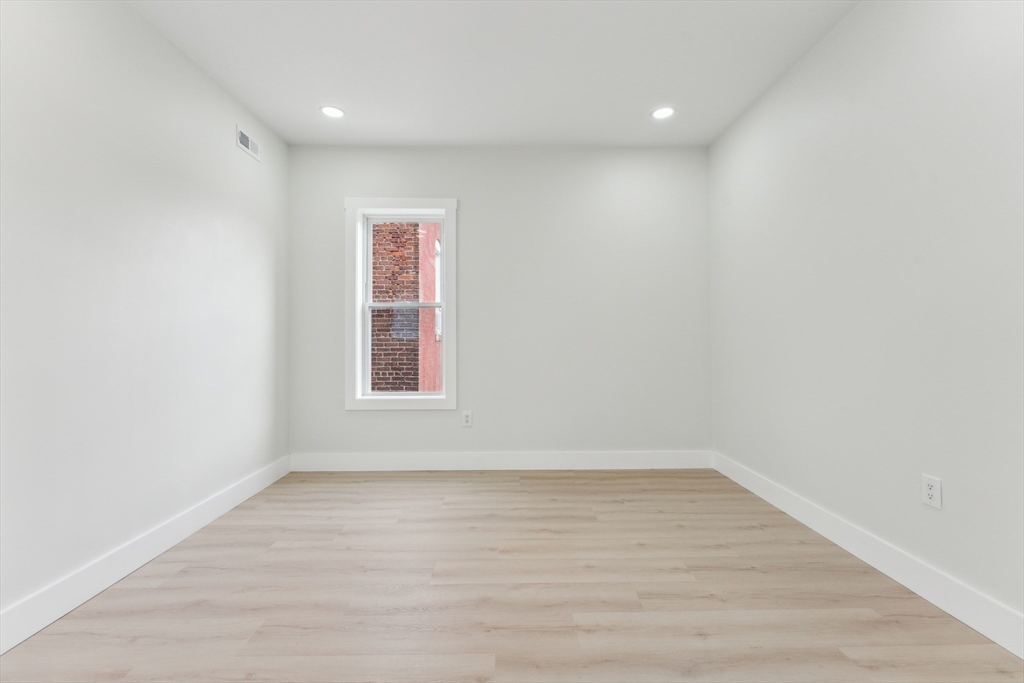 47 Brackett Street, Unit 3 Boston, MA 02135 - Photo 29 of 34 a view of room with window and hardwood floor