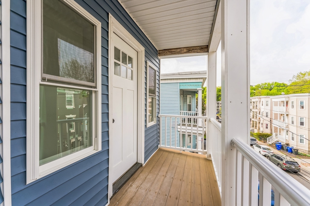 47 Brackett Street, Unit 3 Boston, MA 02135 - Photo 31 of 34 a view of a wooden door and a balcony