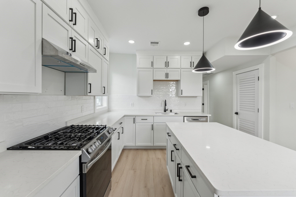 47 Brackett Street, Unit 3 Boston, MA 02135 - Photo 6 of 34 a kitchen with a sink a stove and cabinets