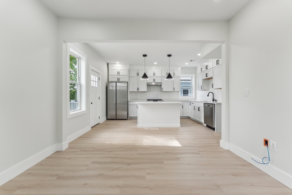 47 Brackett Street, Unit 3 Boston, MA 02135 - Photo 7 of 34 a view of a kitchen with a sink and dishwasher a refrigerator with wooden floor