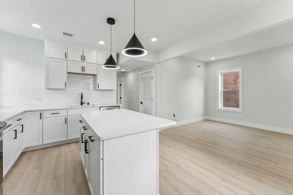 47 Brackett Street, Unit 3 Boston, MA 02135 - Photo 9 of 34 a kitchen with a sink a stove and a window
