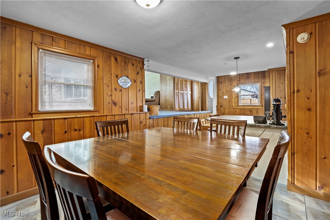 958 West River Road Vermilion, OH 44089 - Photo 13 of 40 Dining room with wood walls and a healthy amount of sunlight