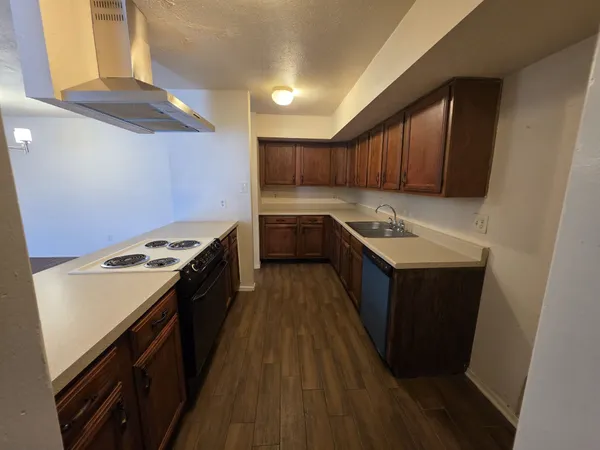 a kitchen with a cabinets and wooden floor