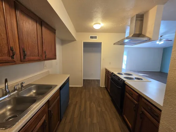 a kitchen with a sink stove and cabinets
