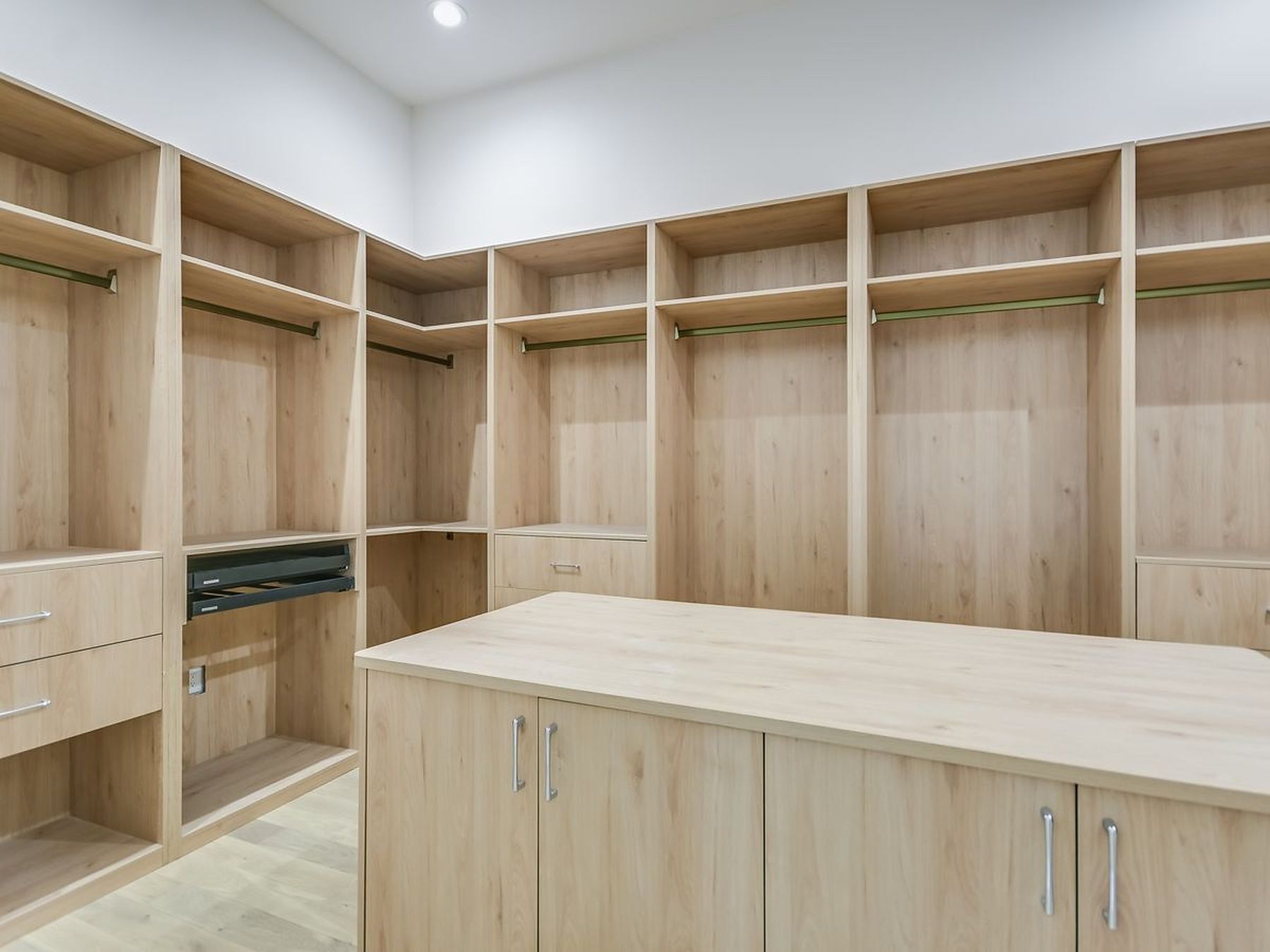 2476 Waymaker Way Austin, TX 78746 - Photo 13 of 31 Ample storage solutions abound in this well-appointed walk-in wardrobe, featuring custom built-ins and a central island.