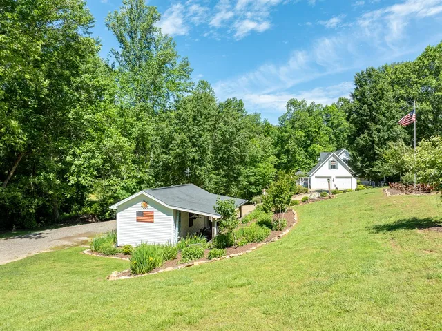 an aerial view of a house with a yard and lake view