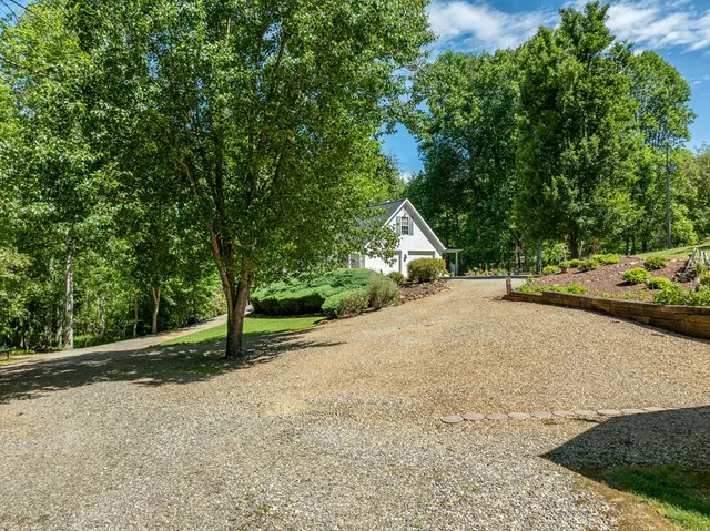 a view of a patio with table and chairs with wooden floor and fence