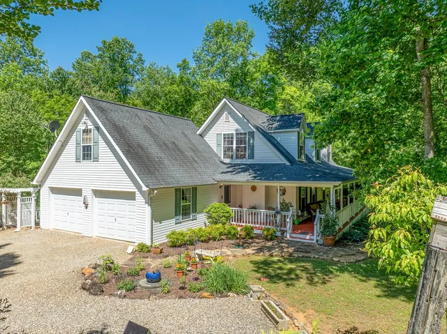 a view of a house with a yard and sitting area