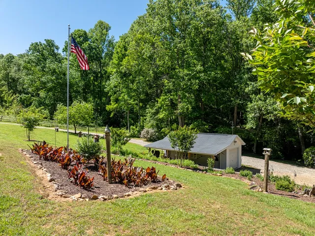a kitchen with granite countertop a sink cabinets and wooden floor