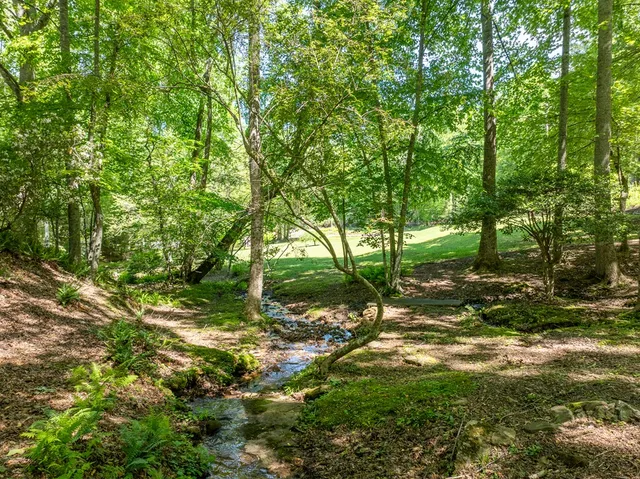 a view of a dining room with furniture and a kitchen