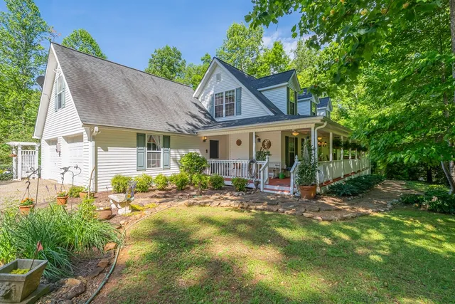 a view of backyard of house with green space
