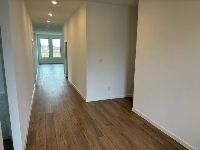 a view of hallway with wooden floor
